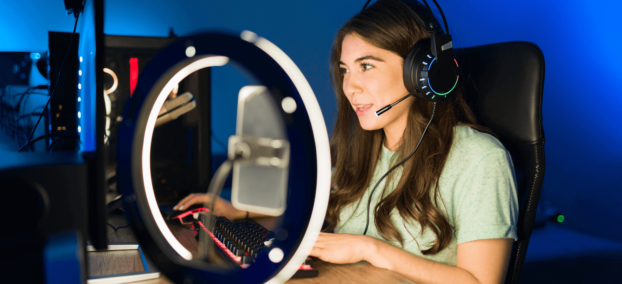 A female influencer in a gaming room plays a computer game for the blog article 5 easy ways to find YouTube influencers